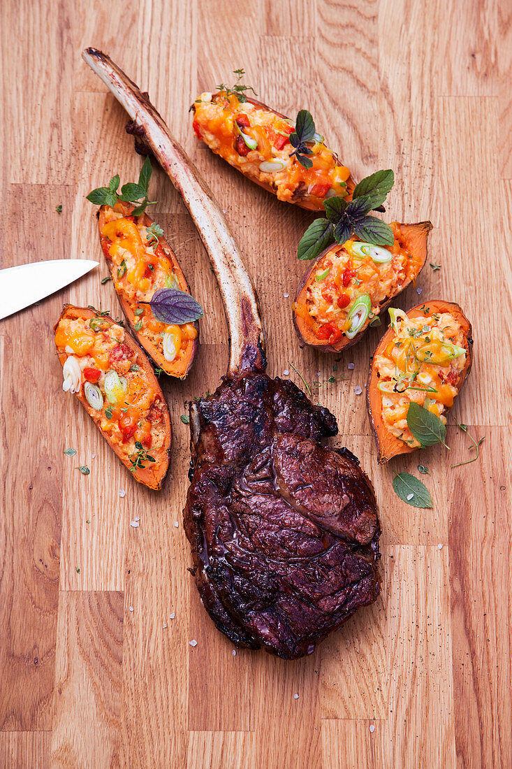 Grilled dry-aged tomahawk steaks with sweet potatoes