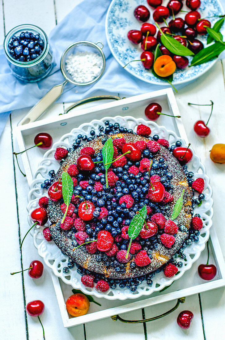 Summer fruit tart with berries, apricots and cherries