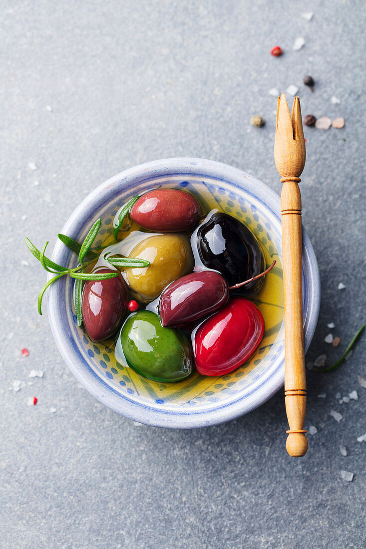 Olives assortment in bowl with oil