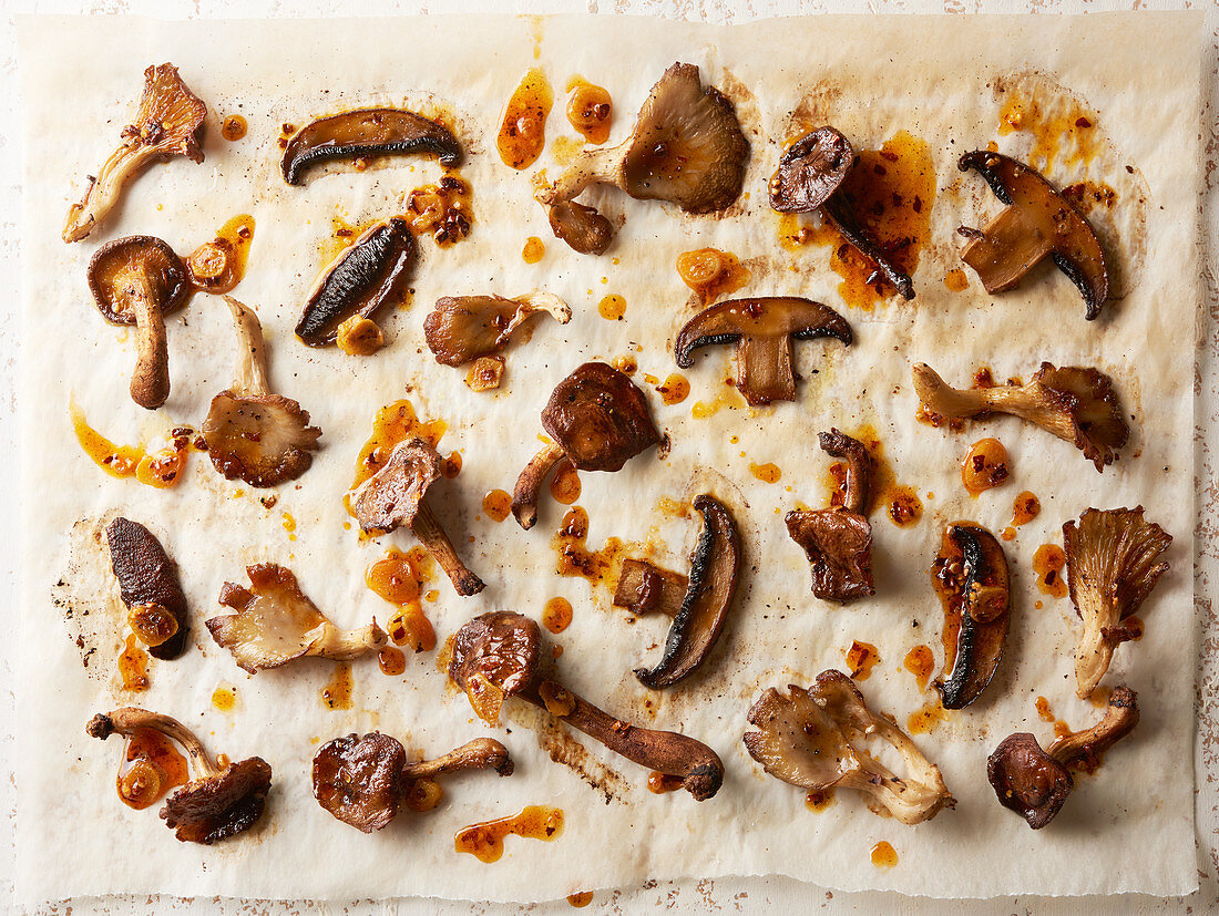 Roasted mixed mushrooms with garlic chili oil on parchemnt