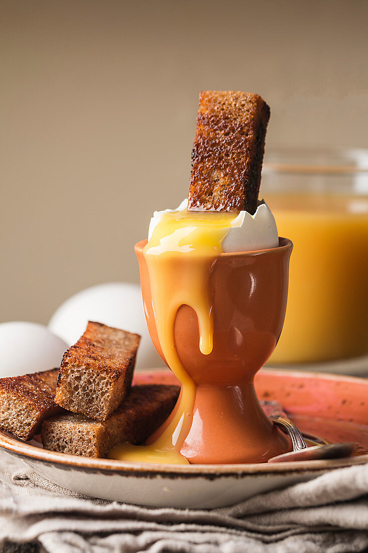 Delicious breakfast with soft boiled eggs and crispy toasts