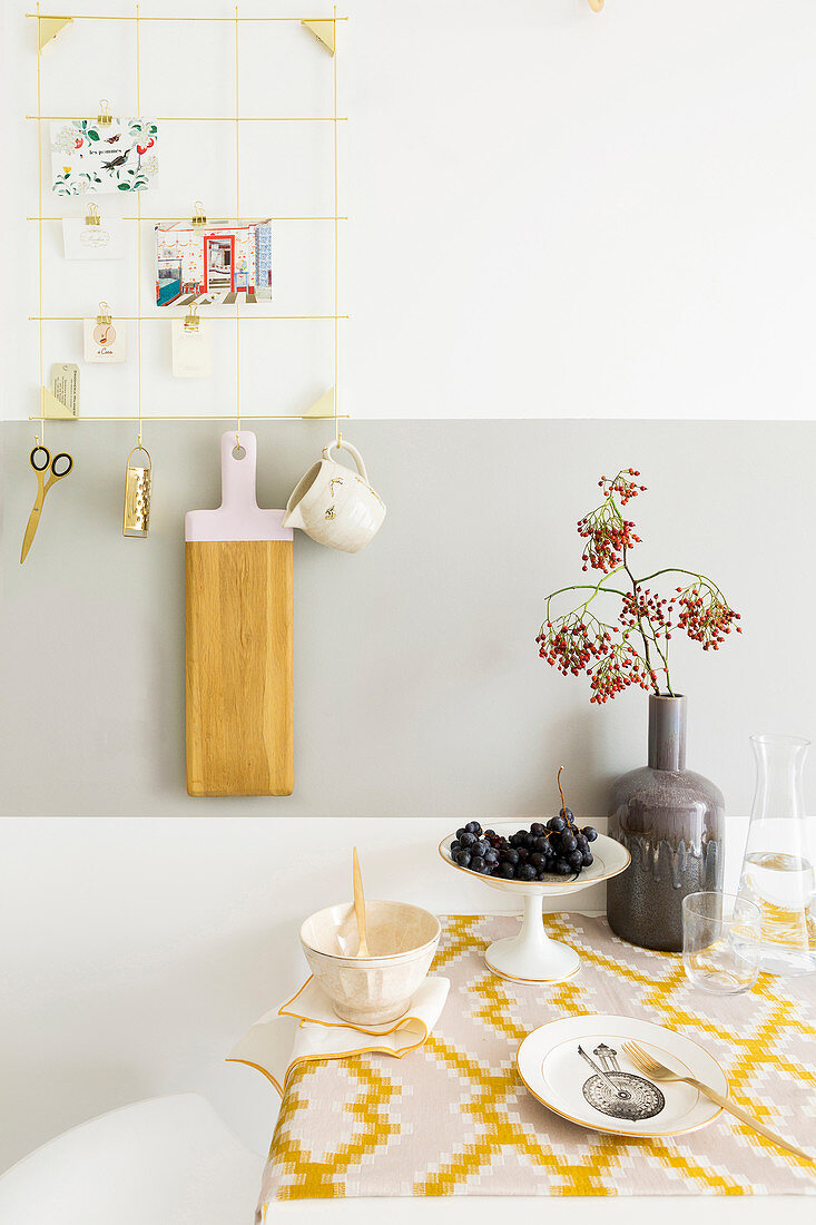 Wall-mounted table with retro tablecloth in kitchen