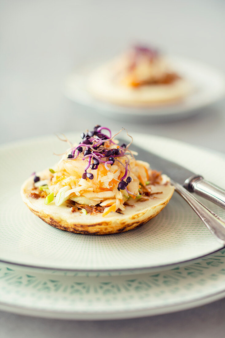 Surabi, coconut pancakes, with pulled pork, spicy cabbage salad and sprouts (Indonesia)