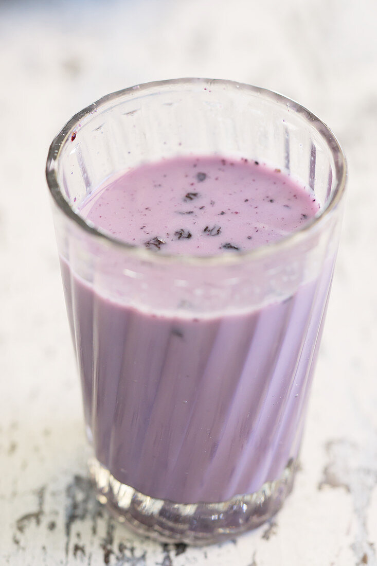 A glass of blueberry milk