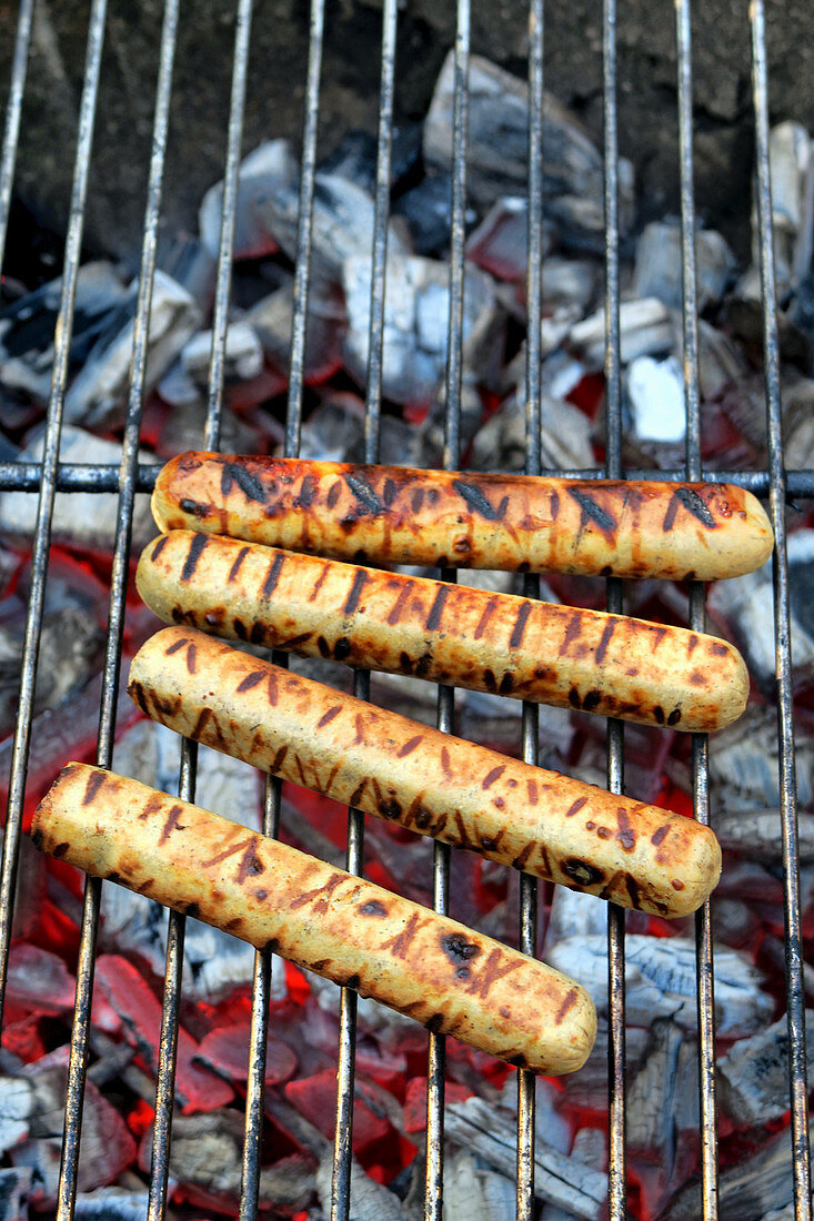 Vegan curry sausages on a barbecue