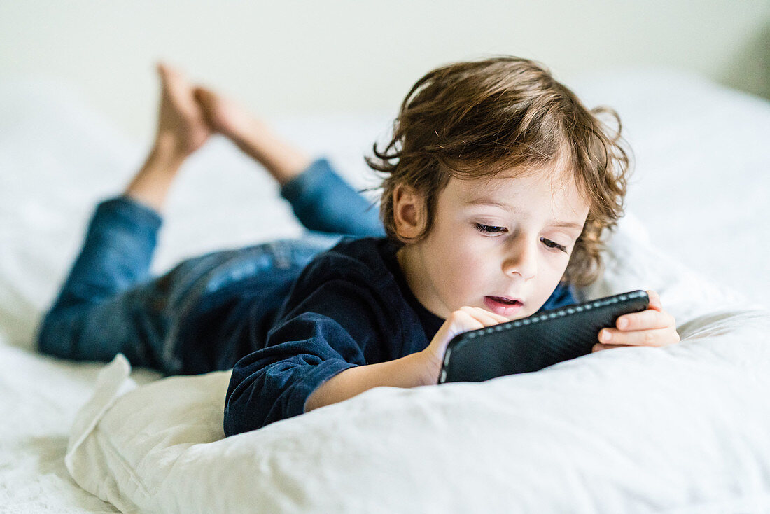 4 year old boy playing with a smartphone