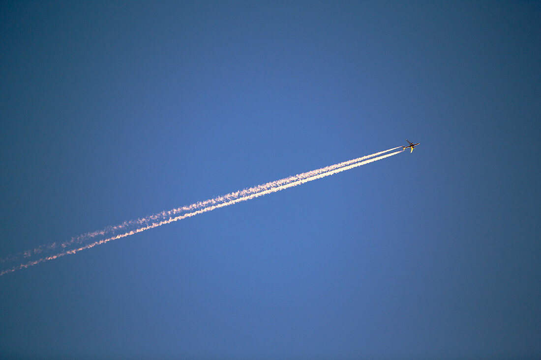 A plane flying over Leicestershire at sunset