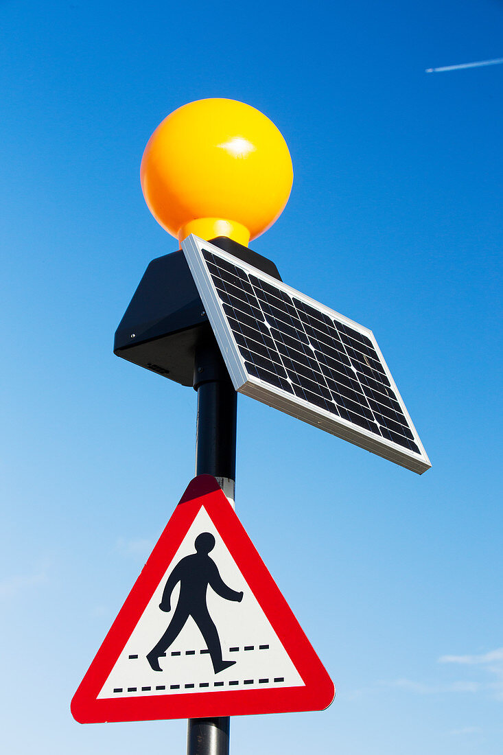A pedestrian crossing light powered by a solar panel