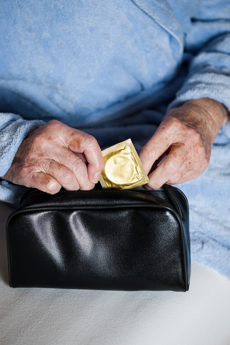 Close-up of elderly woman with condom