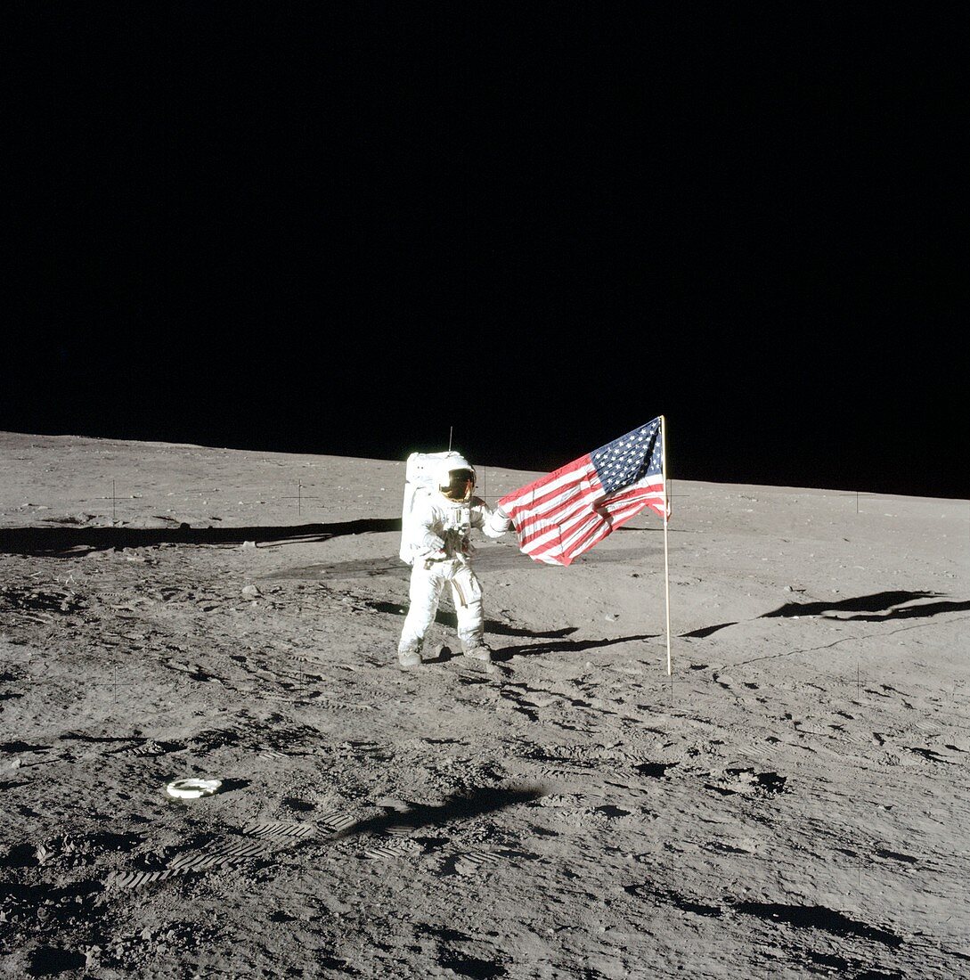Apollo 12 commander unfurling US flag, 1969