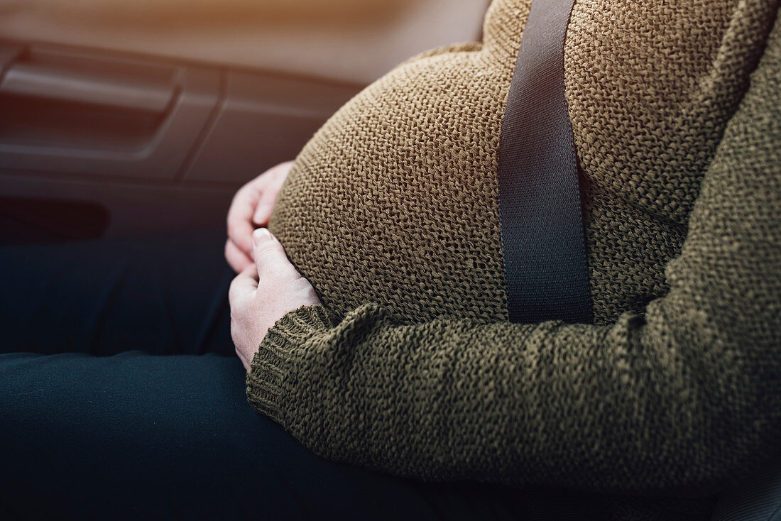 Pregnant woman wearing seat belt