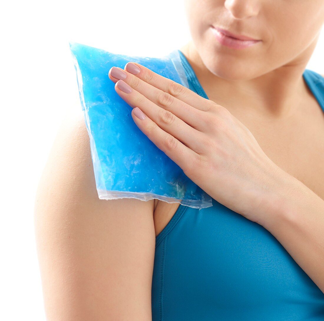 Woman with ice pack on her shoulder