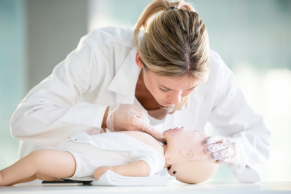 Doctor practising infant CPR