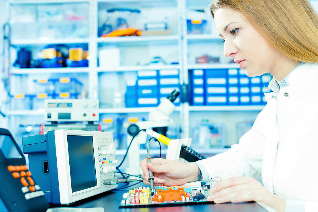 Technician testing circuit in microelectronics laboratory