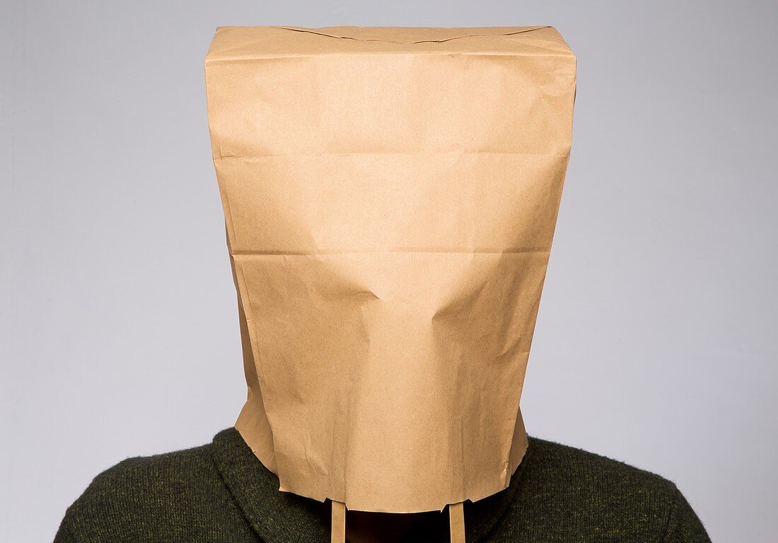 Person with brown paper bag on head