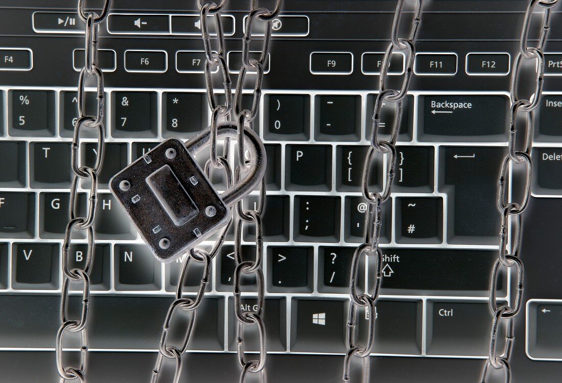 Computer keyboard with metal chains and padlock