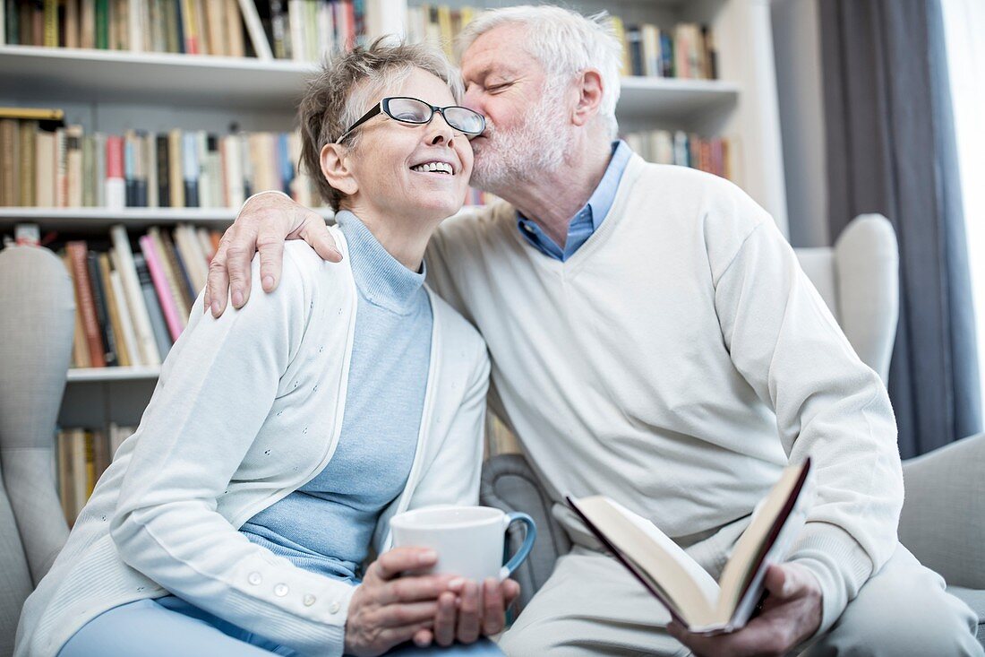 Senior man kissing woman