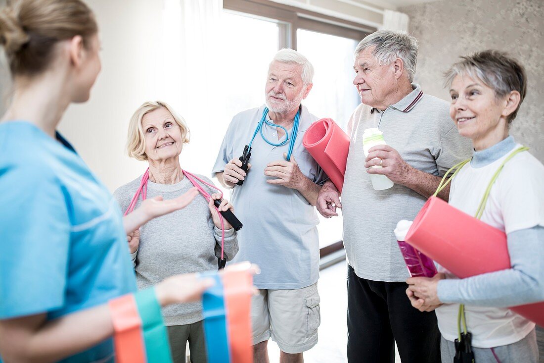 Seniors with physiotherapist in exercise class