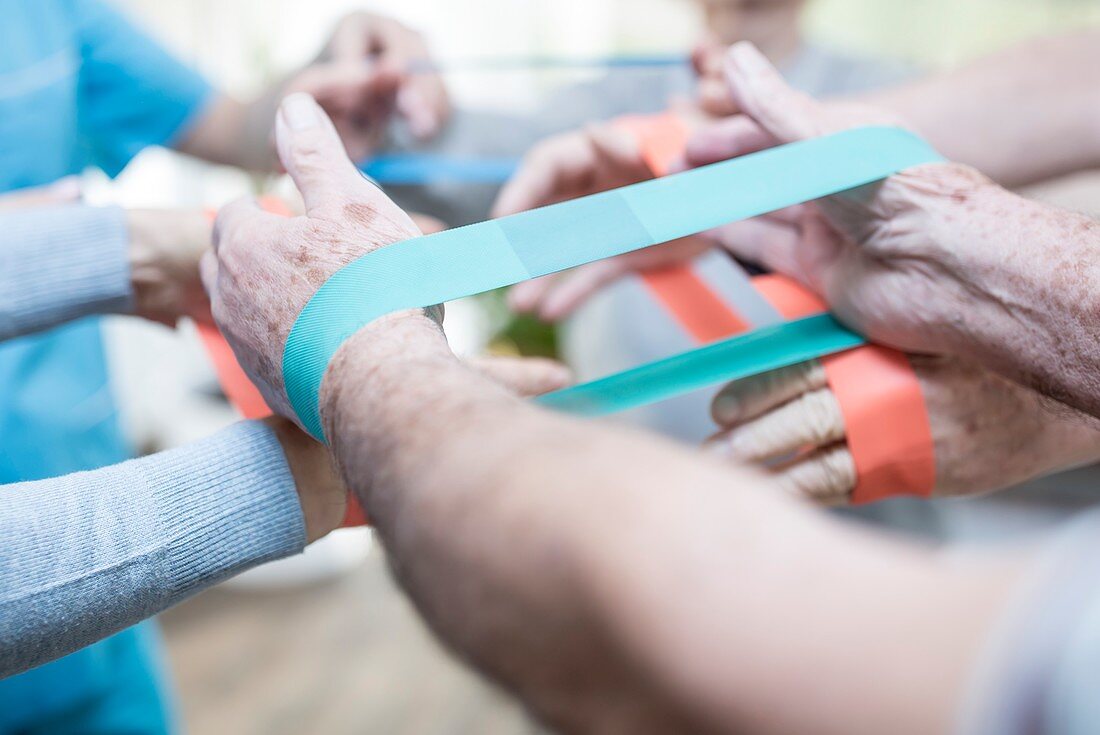 Close up of people using resistance bands