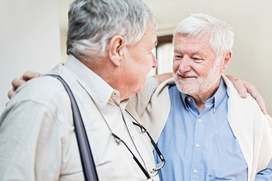 Two men with arms around each other