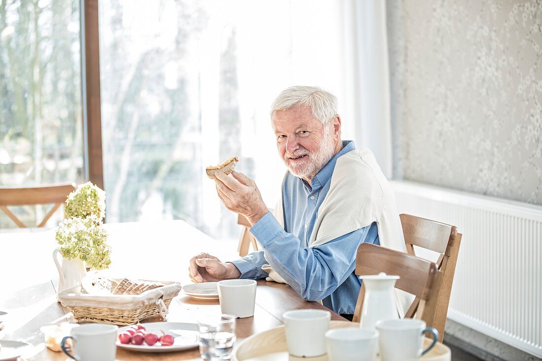 Senior man eating meal