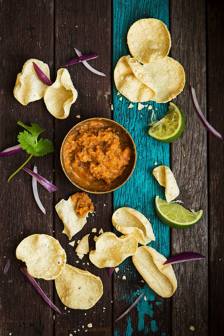 Mini popadoms with dal dip limes and red onion