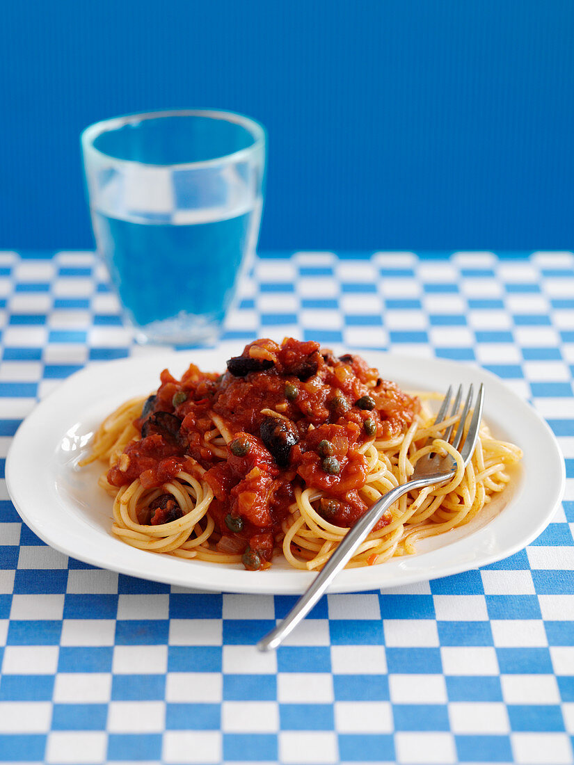 Spaghetti alla puttanesca (with tomatoes, capers and olives)