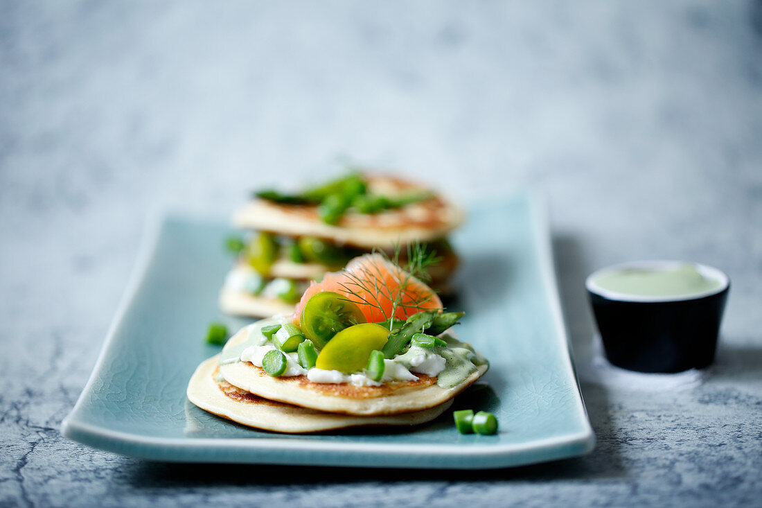 Matcha cream cheese on pancakes with salmon and wide asparagous