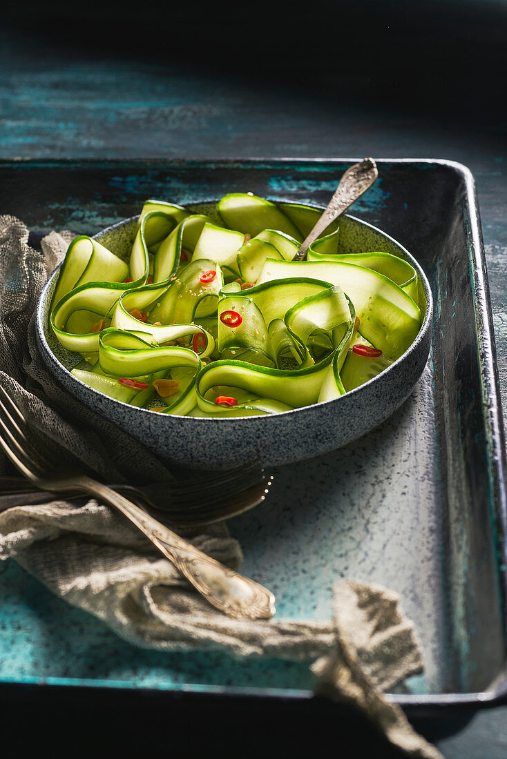 Spicy cucumber salad with peanuts and chili pepper