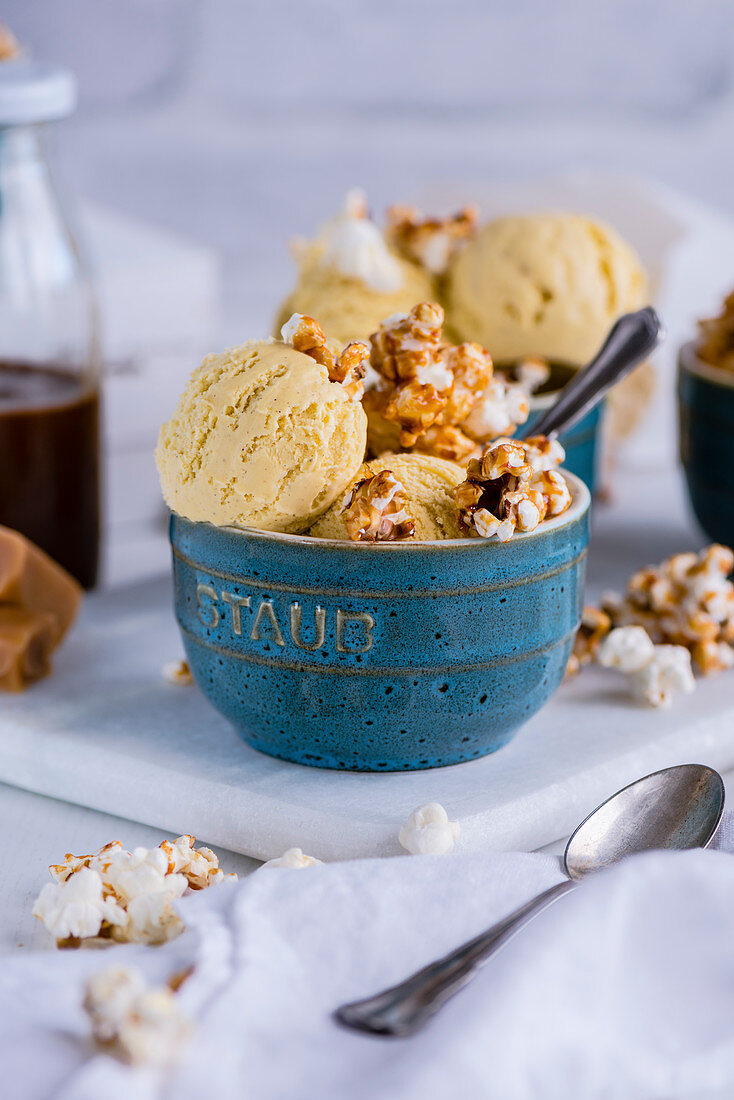 Popcorn ice cream with caramel popcorn in a ceramic bowl