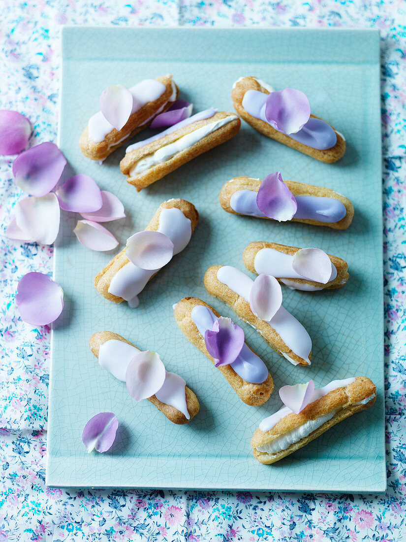 Violet eclairs, with icing and petals