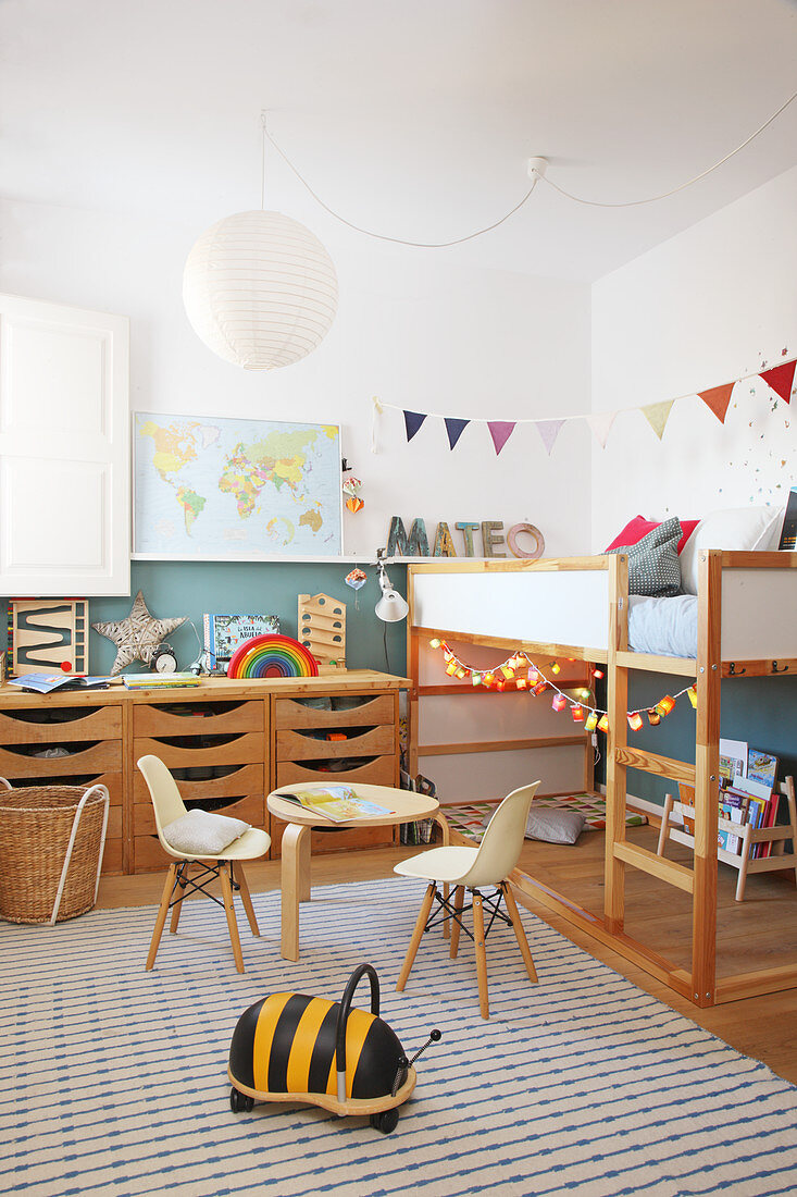 Wooden furniture in child's bedroom with two-tone walls