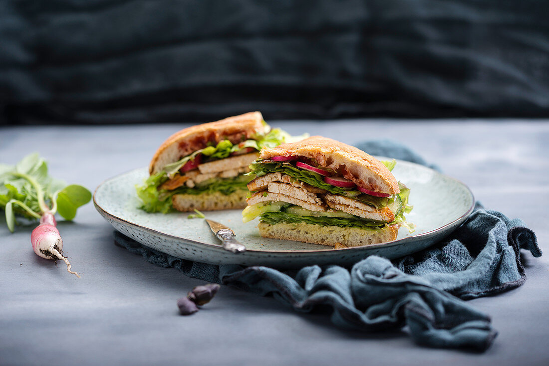 A vegan ciabatta sandwich with tofu and salad