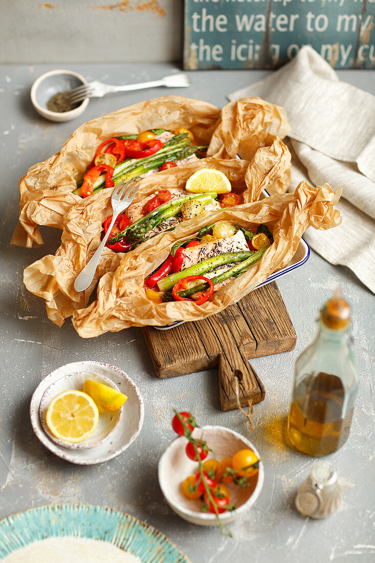 Salmon baked in parchment with pumpkin, asparagus, pepper, tomatoes