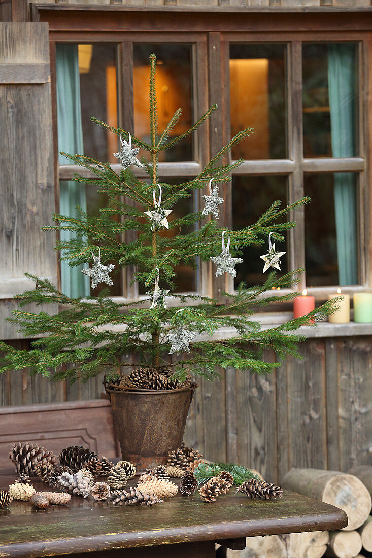 Christmas tree with homemade decorations in metal bucket