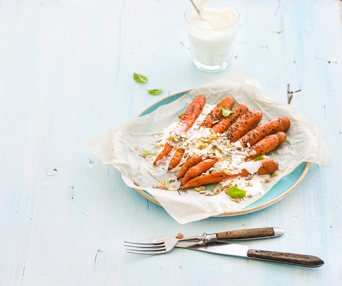 Roasted young carrots with cream and seeds