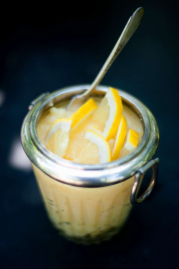 Lemon curd with lemon slices in a jar