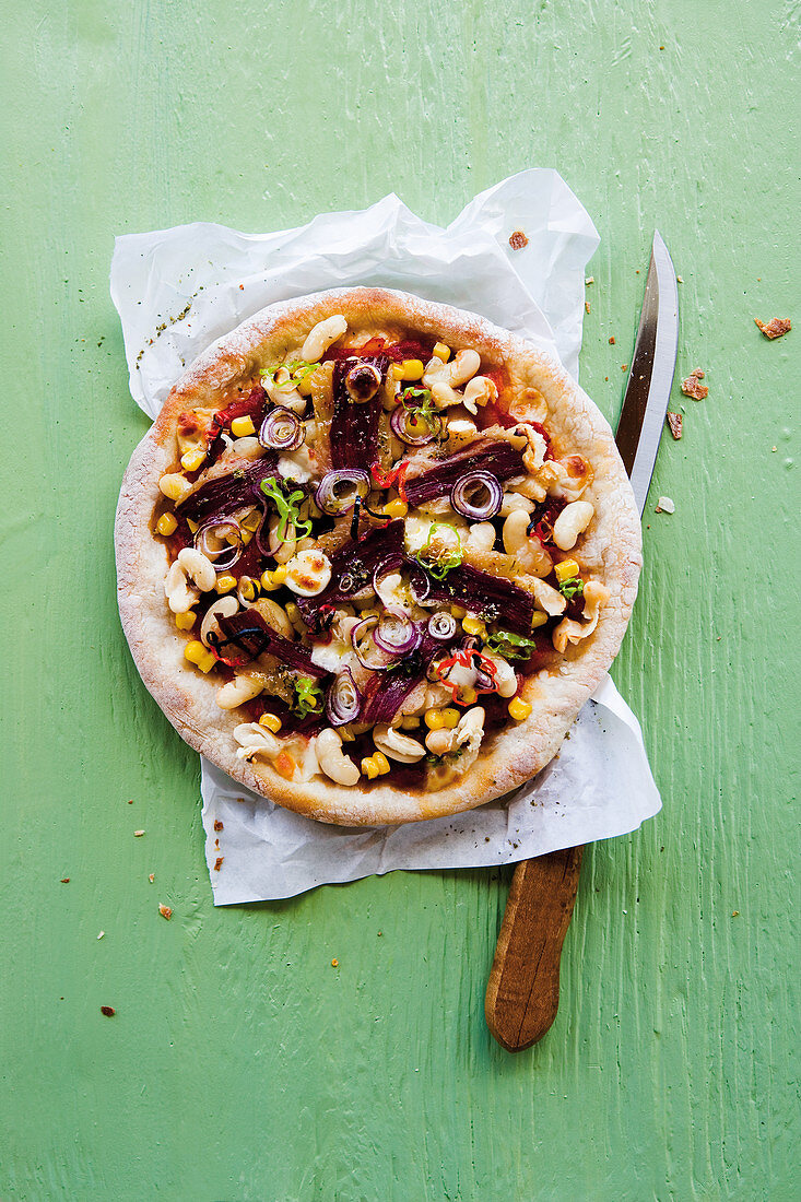 Caribbean pizza with beans, sweetcorn, spicy sausage and Parma ham