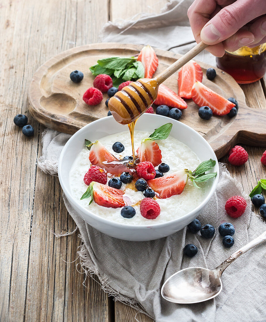 Healthy breakfast - Rice cereal or porridge with berries and honey