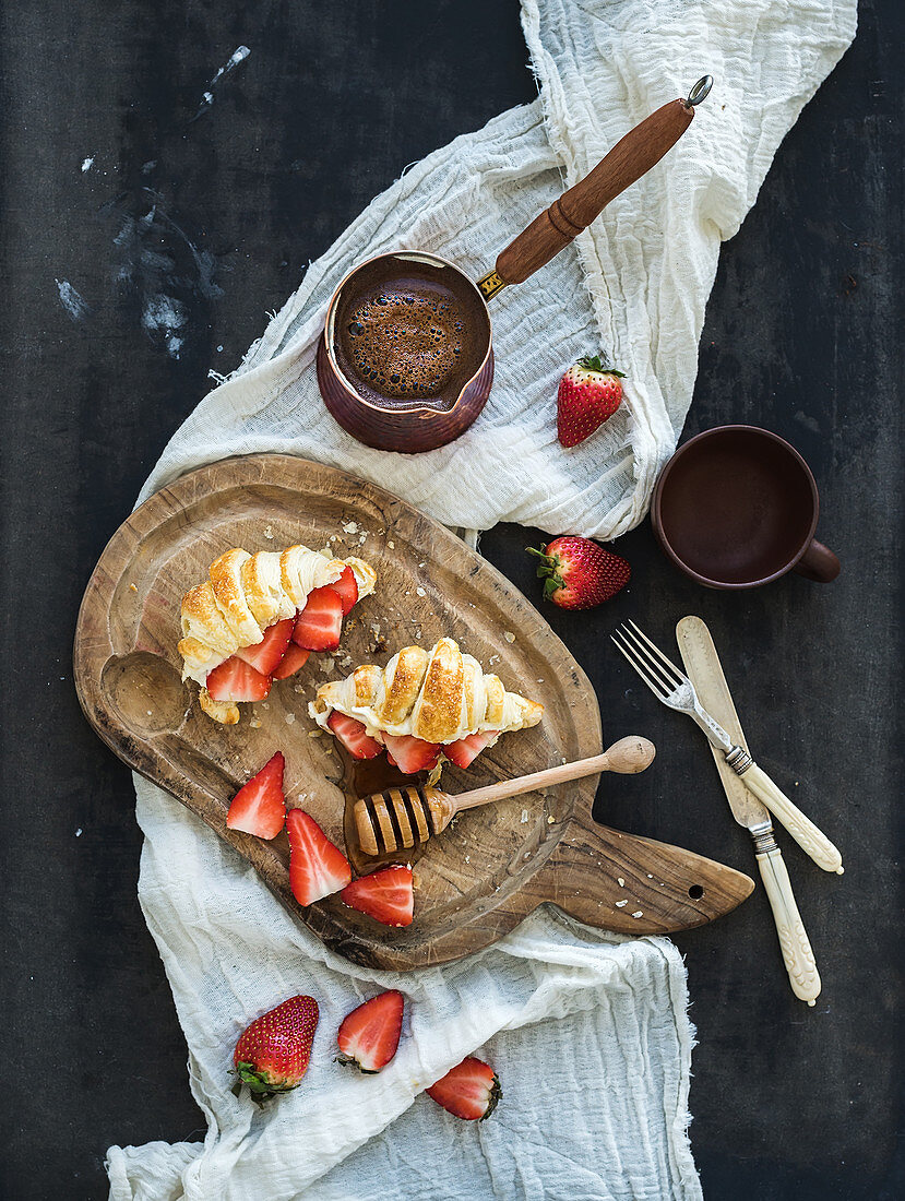 Breakfast set - Freshly baked croissants with strawberries, mascarpone, honey and coffee