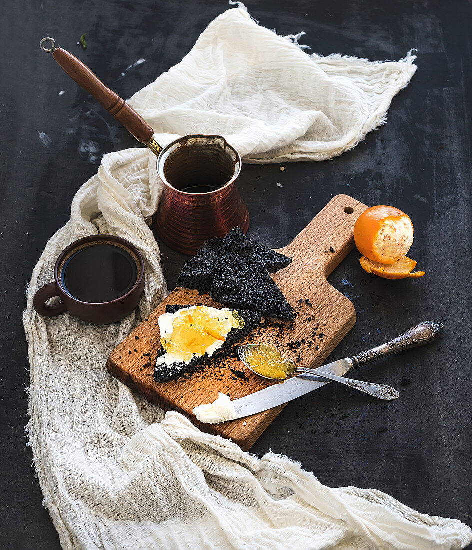 Black bread toasts with tangerine marmelade and mascarpone cheese and fresh coffee