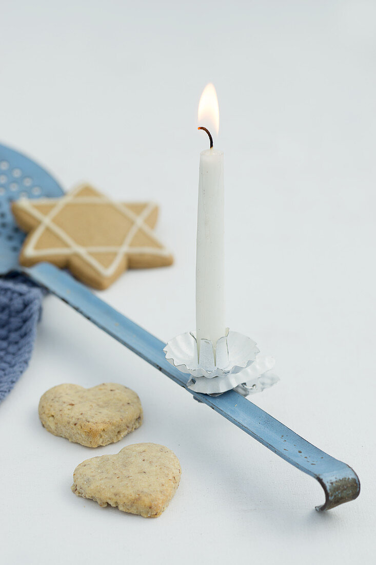 A ladle with a candle and cookies