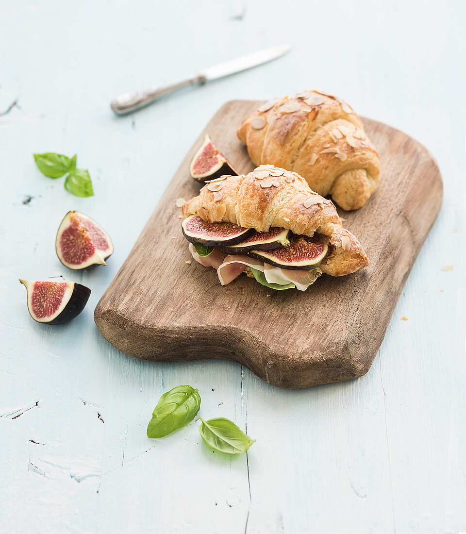 Freshly baked croissants with fresh figs and prosciutto