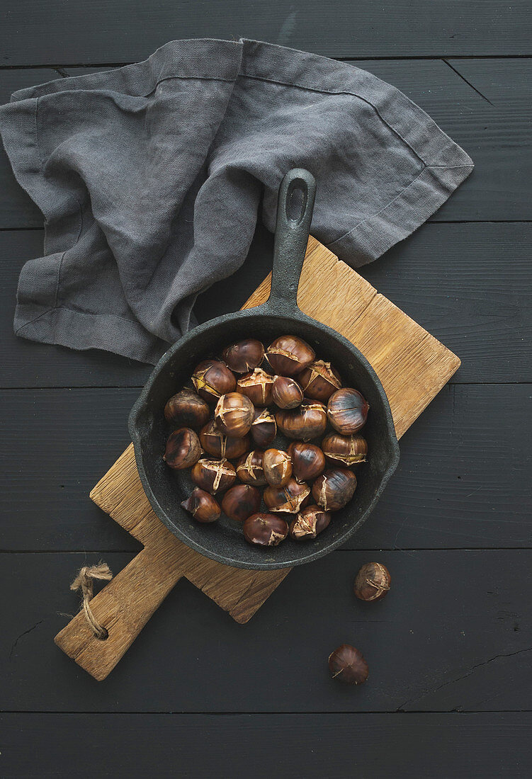 Roasted chestnuts in iron skillet pan