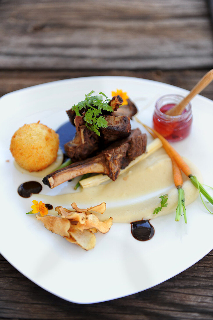 Lamb chops with purée, carrots and vegetable crisps