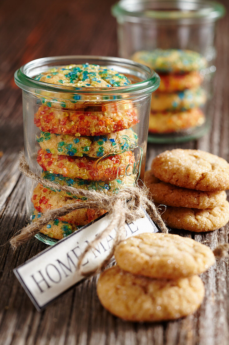 Christmas biscuits with coloured sugar sprinkles in a jar as a gift