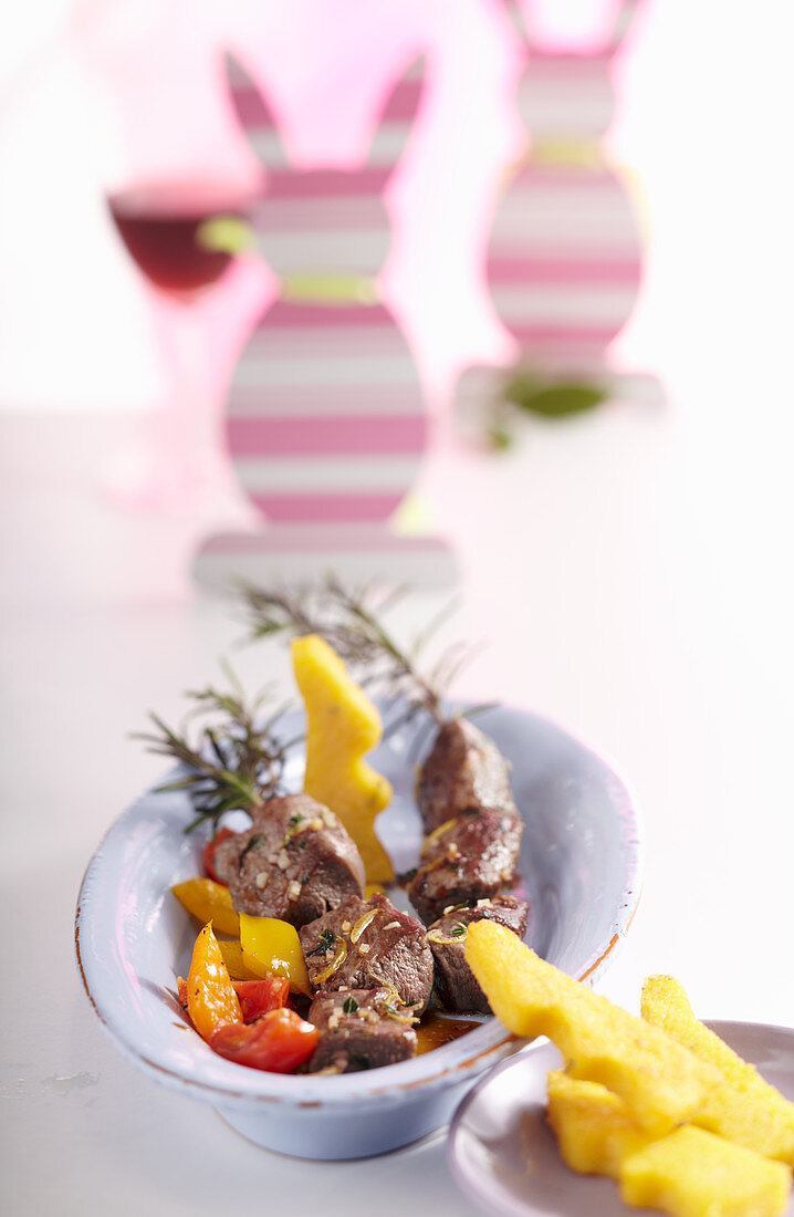 Lamb and rosemary skewers with a pepper medley and polenta rabbits for Easter