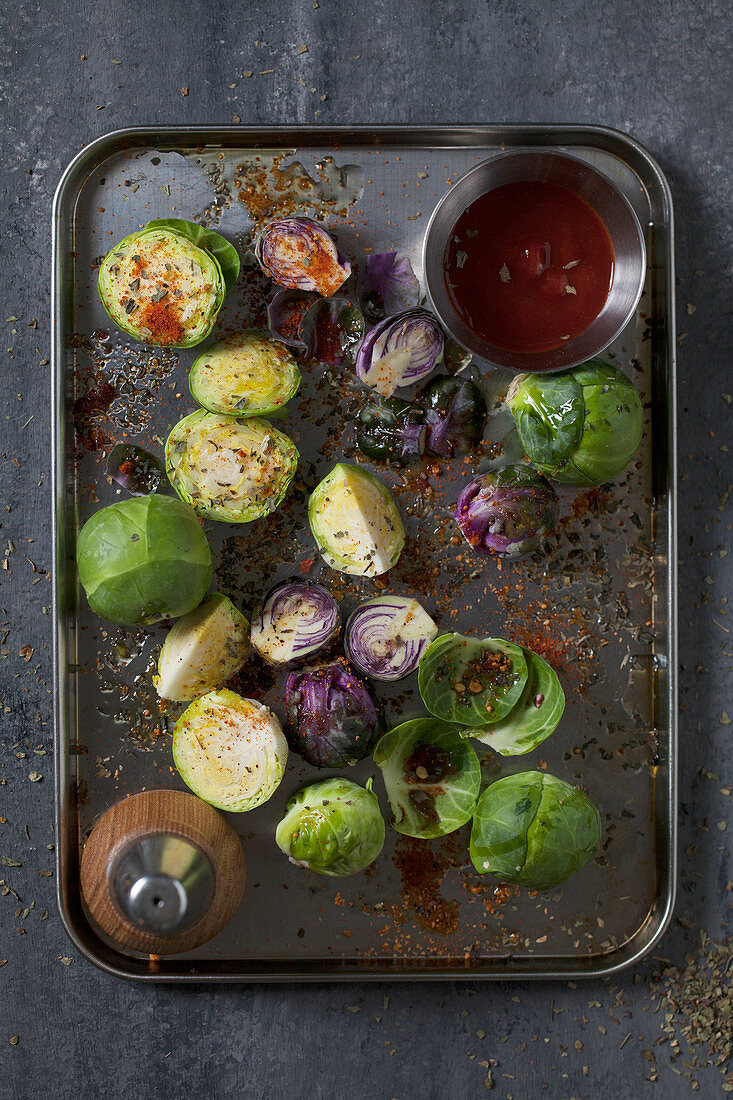 Green and purple Brussels sprouts on an oven tray (top view)