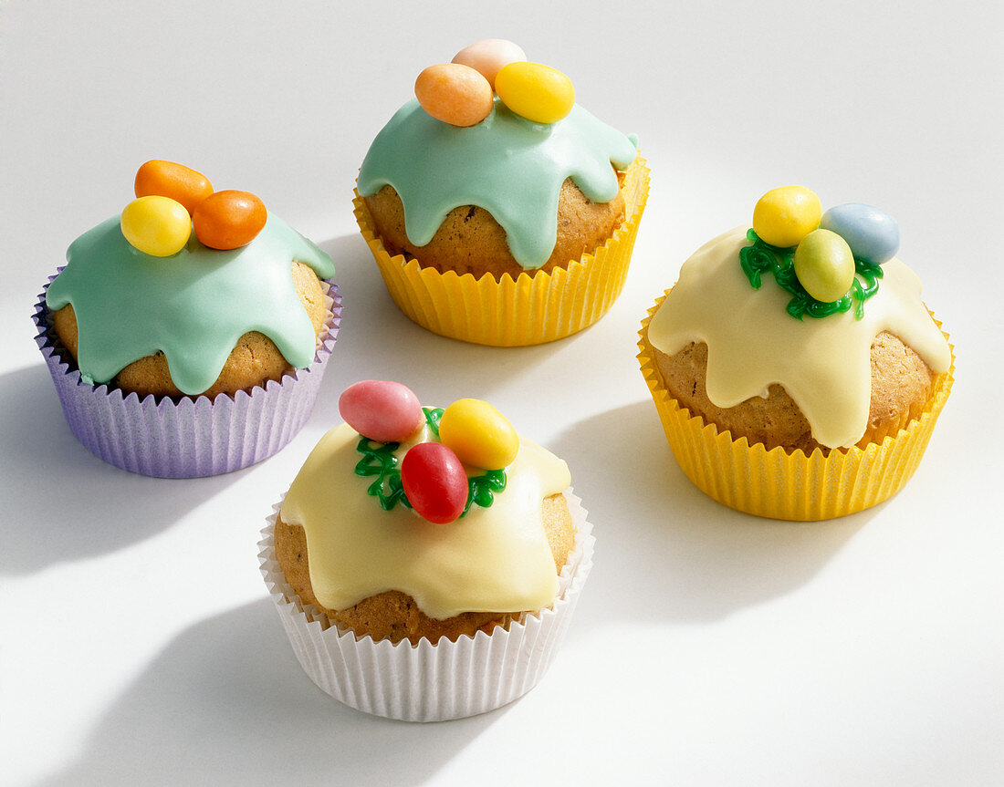 Colourful Easter muffins with icing and sugar eggs
