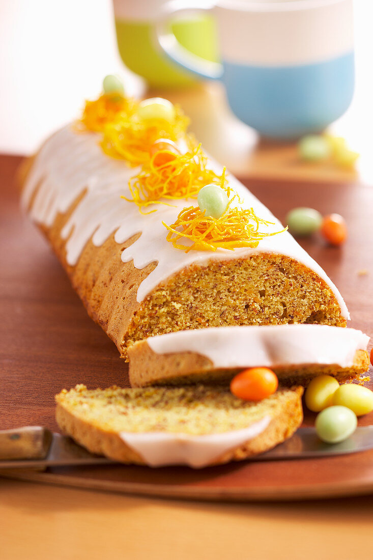 Carrot cake with icing and sugar eggs for Easter